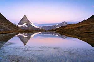 Matterhorn reflected in Riffelsee lake at dawn, Gornergrat, Zermatt, canton of Valais