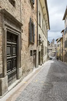 Marche Prints: A medieval alley of the hill town with Piazza Duca Federico in the background, Urbino