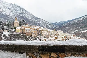 Chill Prints: Medieval stone village under heavy snowfall