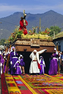 Theatrical Prints: Men carry a huge wooden float of Christ over coloured