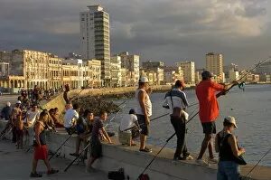 Cuba Gallery: Men fishing at sunset, Avenue Maceo, El Malecon, Havana, Cuba, West Indies
