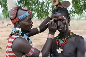 Two men from the Hamer tribe preparing for the Jumping of the Bull ceremony
