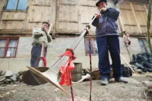 Festivity Prints: Men playing traditional horn instruments at a Lunar New Year festival in the Miao village of Qingman