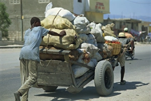 Cart Prints: Men pushing and pulling heavily loaded cart along road