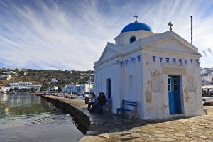 Chora Prints: Three men on a seat beside an old harbour church