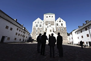 Finland Prints: Men silhoutted against Turku Medieval Castle, Turku, Western Finland, Finland