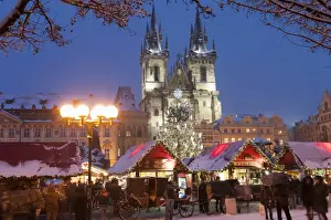 Merry Christmas sign at snow-covered Christmas Market and Tyn Church, Old Town Square, Prague, Czech Republic, Europe