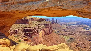 Ecosystems Prints: Mesa Arch frames a stunning view of Canyonlands National Park under a clear sky in Utah during midday
