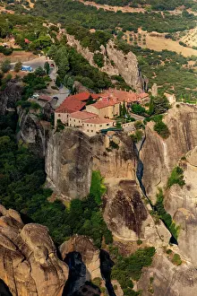 Monasteries Prints: Meteora monastery situated on high rock formation surrounded by cliffs and trees in Thessaly