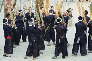 Miao ethnic minority group playing traditional musical bamboo instruments at Basha