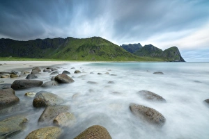 Moody Sky Prints: The midnight sun lights up the waves of the blue sea, Unstad, Vestvagoy, Lofoten Islands