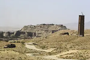 Military graveyard and one of two 12th century minarets that served as models for the Minaret of Jam, with ancient city walls and Citadel in the background, Ghazni