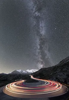 Milky Way and lights of car traces, Bernina Pass, Poschiavo Valley, Engadine, Canton of Graubunden