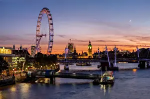 Millenium Wheel (London Eye) with Big Ben on the skyline beyond at sunset, London