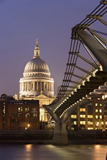 Millennium Bridge and St. Pauls Cathedral, illuminated at dusk, London