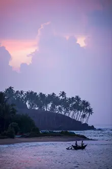 Typical Culture Prints: Mirissa Beach, traditional Sri Lankan outrigger fishing boat at sunrise