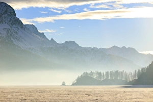 Lake Sils Prints: Mist at sunset on Lake Sils covered with snow, Maloja, Engadine, Canton of Graubunden