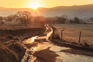 Winter Scene Prints: Misty and frosty sunrise over a country lane in winter