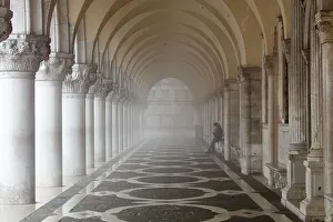 Monochrome Prints: Misty view of pillars with lone woman sitting, Doges Palace, St. Marks Square, Venice