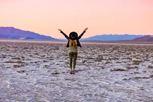 Arms Raised Prints: Model posing for the camera at sunset over the salt flats of the Mesquite Dunes
