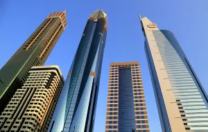 Facades Prints: Modern architecture in central Dubai showcases a mix of design styles with skyscrapers towering against a clear blue