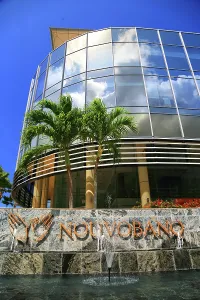 Landscaping Prints: Modern building with reflective glass facade and palm trees in Victoria, Mah, Seychelles