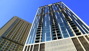 Glass Prints: Modern buildings showcase contemporary design in central Dubai near the main business district under a clear blue sky