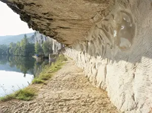 Tow Path Prints: Modern carvings by D. Monnier on wall of tow path beside River Lot, near St