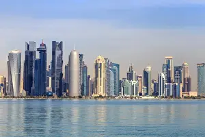 Qatar Prints: Modern city skyline of West Bay, across the calm waters of Doha Bay, from the Dhow Harbour
