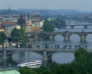 River Vltava Prints: Modern sculpture on the Manesuv Bridge with the Charles Bridge behind, Prague