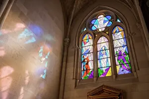 Madrid Prints: Modern stained glass window casting light on a wall in Catedral de Santa Maria la Real de la Almudena