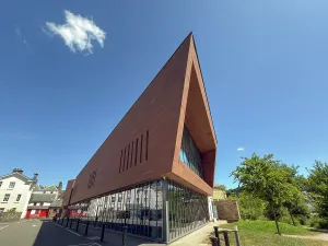 Neighborhood Prints: Modern structure with sharp angles stands in daylight next to traditional buildings in Brecon Powys Wales