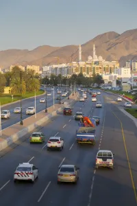 Typically Middle Eastern Prints: Mohammed Al Ameen Mosque and traffic on Sultan Qaboos Street, Muscat, Oman, Middle East