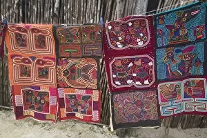Images Dated 9th January 2008: Molas hanging up for sale outside thatched house, Isla Tigre, San Blas Islands