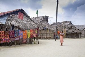 Images Dated 9th January 2008: Molas hanging up for sale outside thatched houses, Isla Tigre, San Blas Islands