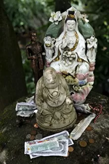 Images Dated 3rd August 2010: Money offering and statues in the garden of Buddhapadipa temple, Wimbledon, London