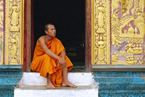 Bare Foot Prints: Monk in the doorway of Wat Xieng Thong