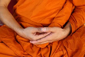 Orange Colour Prints: Monk meditating in Wat Trahimit, Bangkok, Thailand, Southeast Asia, Asia