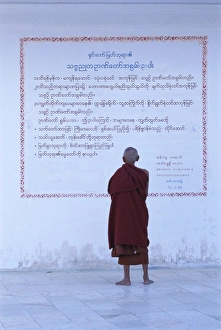 Bare Foot Prints: Monk reading Burmese wall script, Shwedagon, Yangon (Rangoon), Myanmar (Burma), Asia