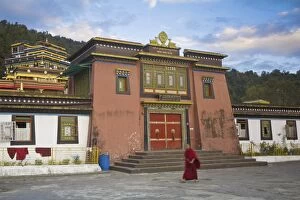Images Dated 9th October 2008: Monk walking past entrance to main monastery building, Rumtek Gompa Complex