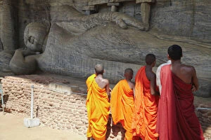 Archaeological Gallery: Monks looking at reclining Buddha statue, Gal Vihara, Polonnaruwa, UNESCO World Heritage Site