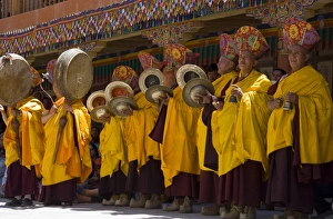 Ladakhi Culture Prints: Monks standing in yellow costumes accompanying those