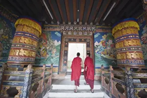 Robes Prints: Monks walking between prayer wheels at Trongsa Dzong (Chokhor Raptentse) dating from 1648