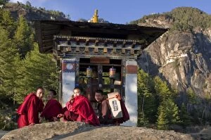 Monks on their way up to the Tiger Nest (Taktshang Goempa) monastery, Bhutan, Asia