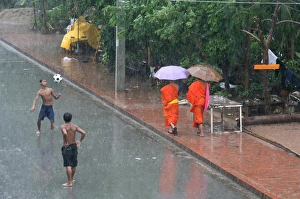 Soccer Prints: Monsoon rain in Luang Prabang, Luang Prabang, Laos, Indochina, Southeast Asia, Asia