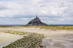 Retreat Prints: Mont Saint-Michel viewed from sandy tidal channels at low tide in Normandy, France