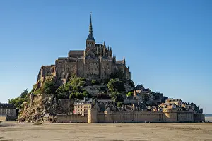 Preservation Prints: Mont St. Michel rises on an island surrounded by sand and water during low tide in France