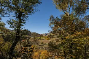 Commemoration Prints: Monument honors defenders of Gunib in Dagestan among colorful autumn trees and blue sky