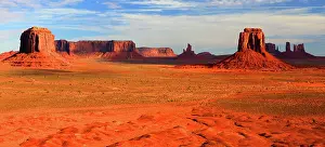 Territory Prints: Monument Valley showcases towering rock formations and red desert landscape under clear blue skies in Utah