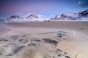 Full moon reflected on sand in the surreal scenery of Skagsanden beach, Flakstad